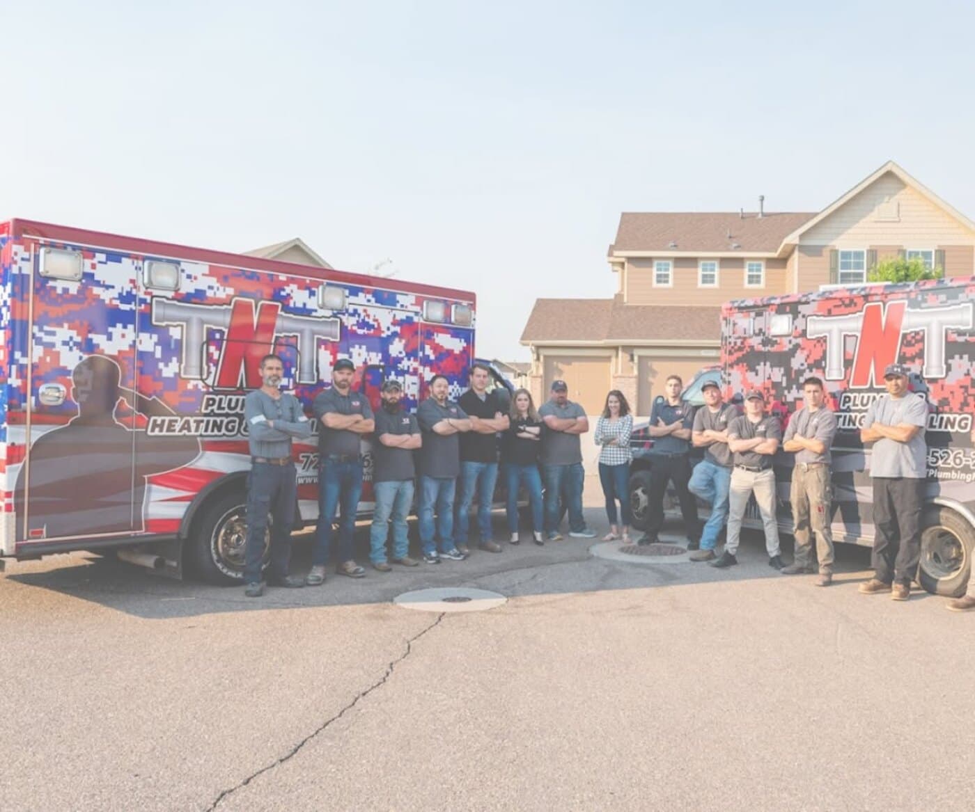 The TNT Home Services team in front of their service vans in Northern Colorado